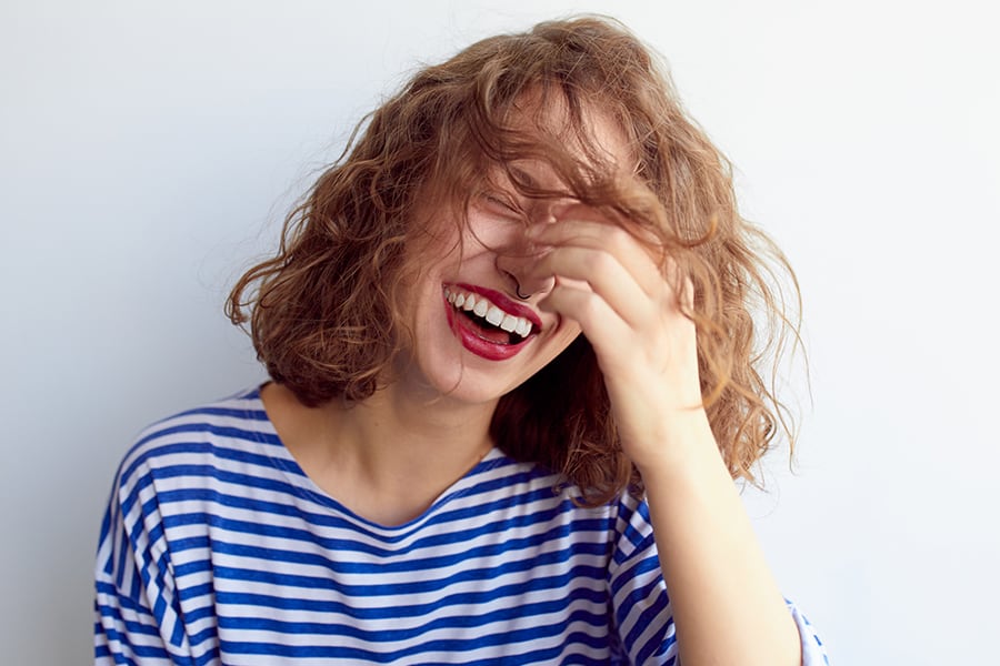 A woman laughing at a funny fake ultrasound prank