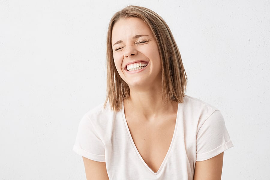 A woman laughing about a prank