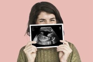 A happy customer holding a fake ultrasound