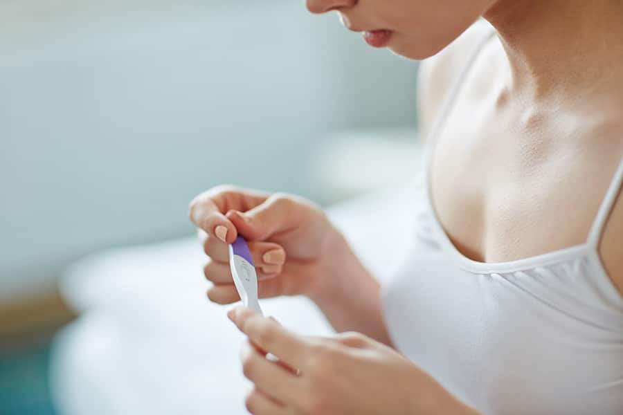 Woman looks at pregnancy test