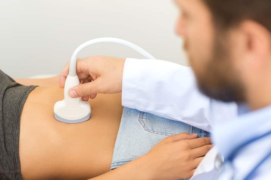 Man doctor uses an ultrasound machine his pov