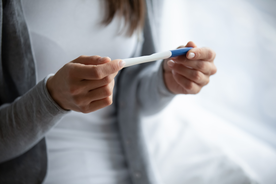 Woman Stares at Pregnancy Test