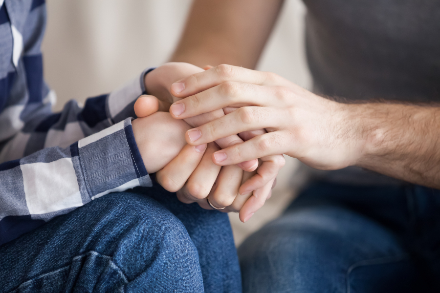 A man holding a woman's hands