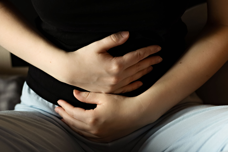 A woman's hands around her belly