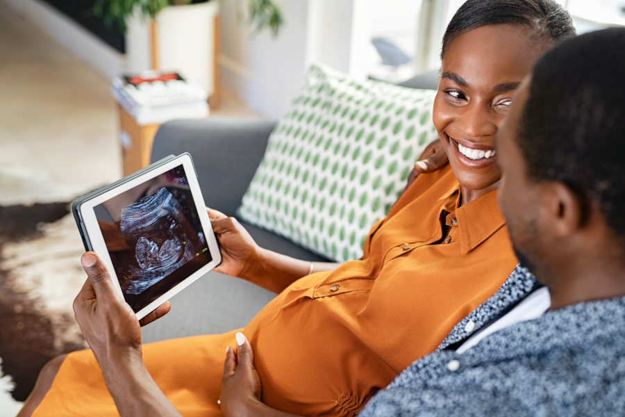 A couple looks at their digital ultrasound