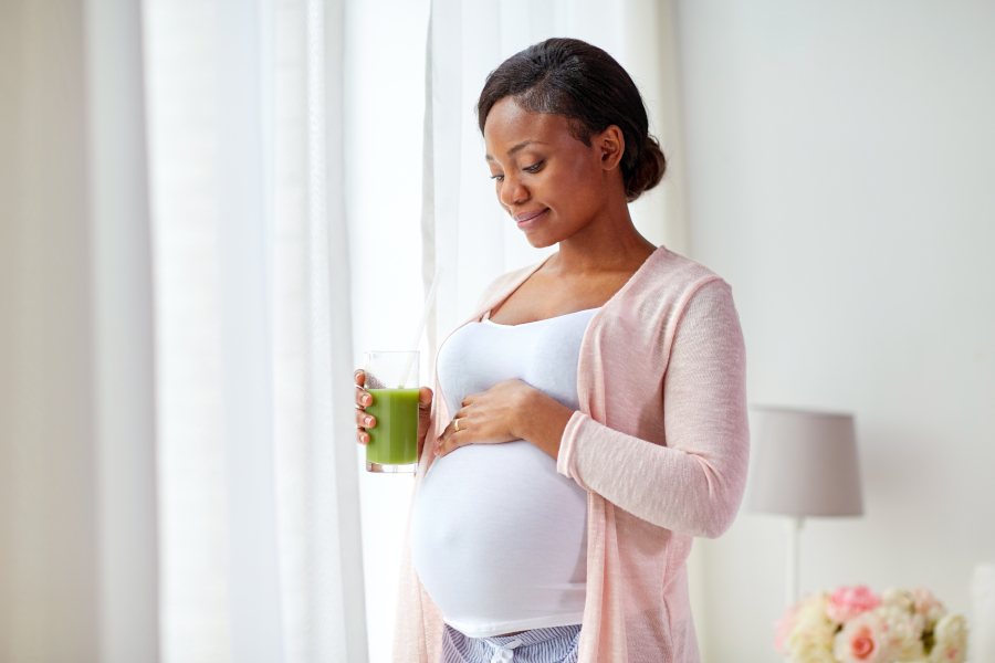 A pregnant woman drinking juice