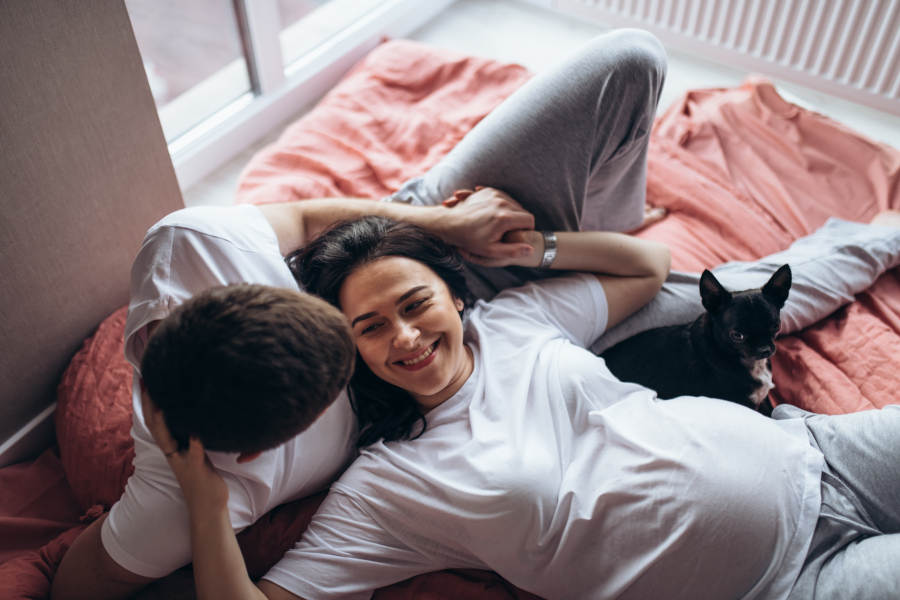 A pregnant couple on a bed