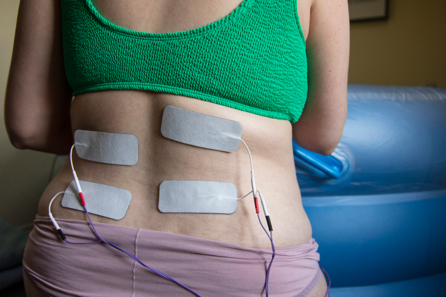 A woman with electrodes on her back