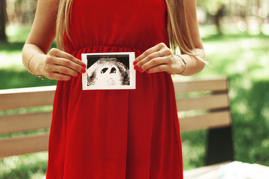 A woman holding a twins ultrasound