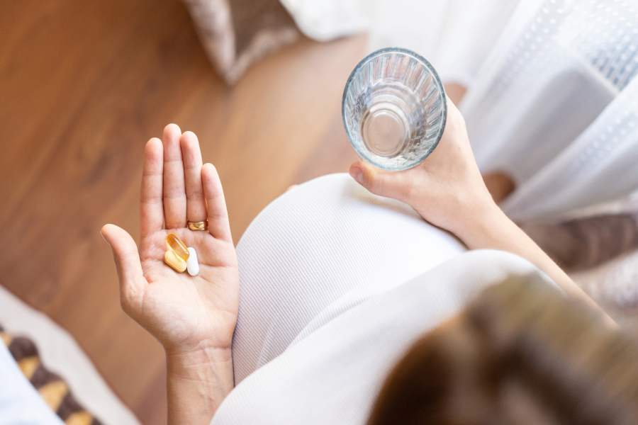 A woman with vitamins and water