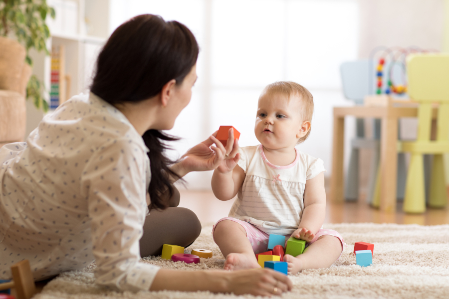 Mom plays with blocks with baby