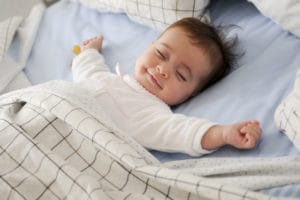 A smiling baby sleeping