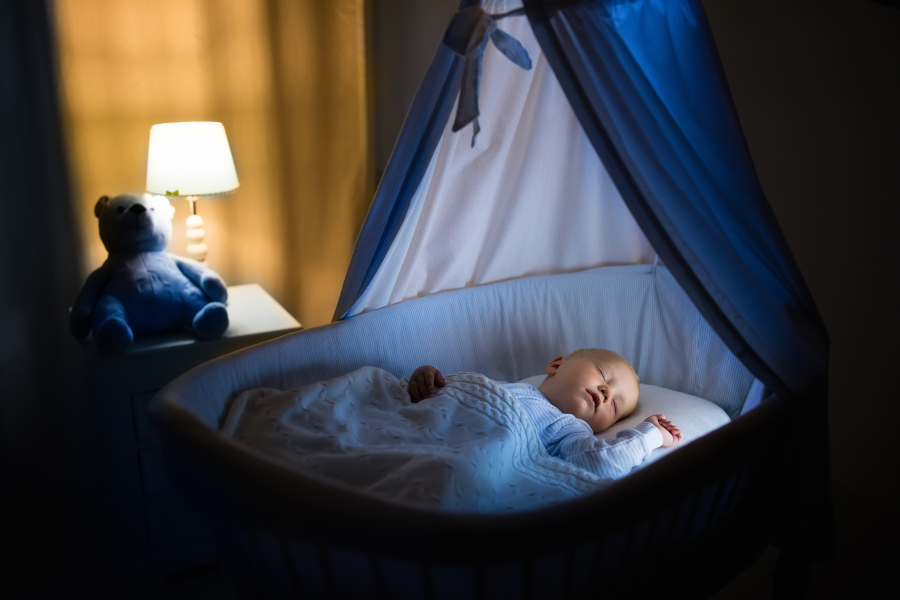 A baby sleeping with a light on