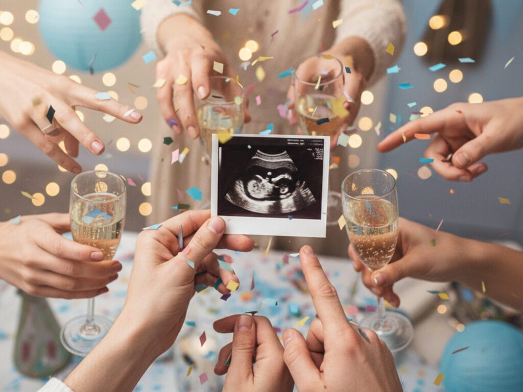 A closeup of an ultrasound at a champagne pregnancy announcement party
